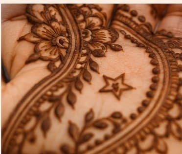 A star tucked into a dense traditional mehendi pattern